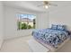 Well-lit bedroom has a large window and a comfortable bed with plush carpeting at 1240 Falconcrest Blvd, Apopka, FL 32712