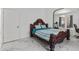 Bedroom with a carved wood bed, marble floors, and adjacent sitting area, offering comfort and style at 1240 Falconcrest Blvd, Apopka, FL 32712