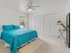 Bright bedroom features a ceiling fan, double closets, and plush carpeting at 1240 Falconcrest Blvd, Apopka, FL 32712