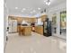 Expansive kitchen with an island, light wood cabinets, stainless steel appliances, and access to the outdoors at 1240 Falconcrest Blvd, Apopka, FL 32712