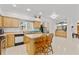 Spacious kitchen featuring light wood cabinets, island with seating, and plenty of counter space, great for cooking at 1240 Falconcrest Blvd, Apopka, FL 32712