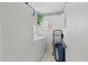 Well-lit laundry room featuring a washer, dryer, storage shelves, and a laundry basket, offering convenience at 1240 Falconcrest Blvd, Apopka, FL 32712