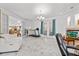 Open living room with marble floors, a fireplace, and French doors, creating an inviting and bright atmosphere at 1240 Falconcrest Blvd, Apopka, FL 32712