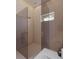 Sleek glass-enclosed shower with a modern fixtures and tile floor at 12818 Brunello Cir, Clermont, FL 34711