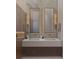 Contemporary bathroom features double sinks, marble accents, and stylish lighting at 12818 Brunello Cir, Clermont, FL 34711