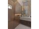 Sleek bathroom featuring a glass enclosed shower, built-in shelf, and elegant vanity with mirror at 12818 Brunello Cir, Clermont, FL 34711