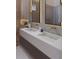 Modern bathroom featuring double sinks, gold fixtures, and marble walls with backlit mirrors for a luxurious feel at 12818 Brunello Cir, Clermont, FL 34711