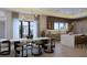 Elegant dining room featuring a modern light fixture, a marble table, and views to the kitchen at 12818 Brunello Cir, Clermont, FL 34711