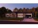 Stunning single-story home with modern elevation, manicured lawn, and a paver driveway leading to a two-car garage at 12818 Brunello Cir, Clermont, FL 34711