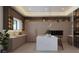Modern kitchen features an island with marble countertop, lots of storage, and bar stool seating at 12818 Brunello Cir, Clermont, FL 34711