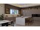 Modern kitchen featuring an island with seating, stainless steel appliances, and custom cabinetry at 12818 Brunello Cir, Clermont, FL 34711