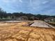 Suburban new construction shows foundation of multiple homes ready for framing with surrounding homes and sunny skies at 12818 Brunello Cir, Clermont, FL 34711
