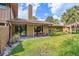 Beautiful backyard with a covered patio, picnic table, lush lawn and tropical landscaping at 134 Heron Bay Cir, Lake Mary, FL 32746