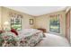 Bedroom view with a floral comforter, two windows, and a closet at 134 Heron Bay Cir, Lake Mary, FL 32746