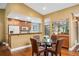 Bright dining area with views of the kitchen, a skylight, and ample space for entertaining at 134 Heron Bay Cir, Lake Mary, FL 32746