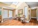 Bright foyer with skylight, hardwood floors, and decorative mirror, creating a welcoming entrance at 134 Heron Bay Cir, Lake Mary, FL 32746