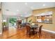 Open-concept living space with hardwood floors and views of the dining area and updated kitchen at 134 Heron Bay Cir, Lake Mary, FL 32746