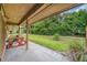 Covered patio featuring a picnic table and a peaceful view of the lush green backyard and walking path at 134 Heron Bay Cir, Lake Mary, FL 32746