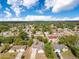 Wide aerial view showcases a lush, green neighborhood filled with mature trees and well-maintained homes at 1340 Bakersfield Ave, Deltona, FL 32725