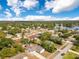 A panoramic aerial shot of a residential neighborhood near a lake, lush with mature trees and clear blue skies at 1340 Bakersfield Ave, Deltona, FL 32725