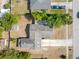 An aerial view of a single-story home with neutral roof, complimented by mature trees and surrounding residential properties at 1340 Bakersfield Ave, Deltona, FL 32725