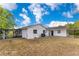 Wide view of the backyard featuring a screened-in patio and a shed at 1340 Bakersfield Ave, Deltona, FL 32725