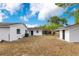 Spacious backyard featuring a well-maintained lawn and storage building under a bright blue sky with scattered clouds at 1340 Bakersfield Ave, Deltona, FL 32725