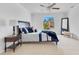 Bright bedroom featuring tiled floors, a ceiling fan, and a side table with lamp at 1340 Bakersfield Ave, Deltona, FL 32725