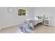 Cozy bedroom featuring a bed, nightstand, tile flooring, and natural light at 1340 Bakersfield Ave, Deltona, FL 32725