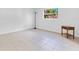 Bright bedroom showcasing tile floors, a window, and a classic wood side table at 1340 Bakersfield Ave, Deltona, FL 32725