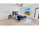 Inviting bedroom with tiled floor, ceiling fan, and window views to the outdoors at 1340 Bakersfield Ave, Deltona, FL 32725