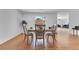 A well-lit dining area showcases wood flooring and a cozy table set at 1340 Bakersfield Ave, Deltona, FL 32725