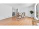 Bright dining area with wood floors, a modern table setting, and a view of the backyard at 1340 Bakersfield Ave, Deltona, FL 32725