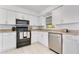 Updated kitchen with white cabinets, stainless appliances, and a bright, clean aesthetic at 1340 Bakersfield Ave, Deltona, FL 32725