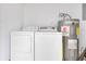 Functional laundry area featuring a washer, dryer, and water heater at 1340 Bakersfield Ave, Deltona, FL 32725