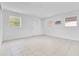 Spacious empty room with tiled floors and multiple windows for ample natural light at 1340 Bakersfield Ave, Deltona, FL 32725
