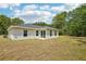 Exterior view of a one story home and grassy backyard at 13881 Sw 80Th Ave, Ocala, FL 34473
