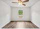 Bright bedroom features wood-look flooring, a ceiling fan, and a window at 13881 Sw 80Th Ave, Ocala, FL 34473