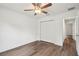 Bedroom featuring wood-look floors, closet access, and a ceiling fan at 13881 Sw 80Th Ave, Ocala, FL 34473