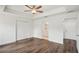Bedroom showcasing a double door closet, wood-look floors, and bathroom access at 13881 Sw 80Th Ave, Ocala, FL 34473