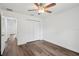 This bedroom showcases wood-look flooring, a ceiling fan, and closet access at 13881 Sw 80Th Ave, Ocala, FL 34473