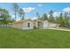 A single-story home with a large, well-manicured yard, mature trees, and a driveway leading to the garage at 13881 Sw 80Th Ave, Ocala, FL 34473