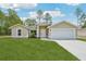 Charming single-story home with a two-car garage, well-maintained lawn and landscaping at 13881 Sw 80Th Ave, Ocala, FL 34473