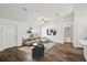 Bright living room featuring hardwood floors, modern lighting, and a beige sectional sofa at 13881 Sw 80Th Ave, Ocala, FL 34473