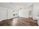 Spacious living room with wood-look flooring, a ceiling fan, and bright natural light at 13881 Sw 80Th Ave, Ocala, FL 34473