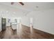 A bright, open-concept living space with vaulted ceilings, wood-look floors, and recessed lighting at 13881 Sw 80Th Ave, Ocala, FL 34473