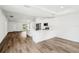 Open-concept kitchen and living space with vaulted ceilings and wood-look flooring at 13881 Sw 80Th Ave, Ocala, FL 34473