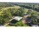 An aerial view of a community park with playground, shade structure, and surrounding mature trees and lush greenery at 14003 Sobrado Dr, Orlando, FL 32837