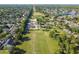 Bird's eye view shows community homes with mature trees and expansive green space with powerlines stretching out at 14003 Sobrado Dr, Orlando, FL 32837