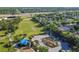 Aerial view features community park with playground, geometric topiary, sports field, and homes at 14003 Sobrado Dr, Orlando, FL 32837